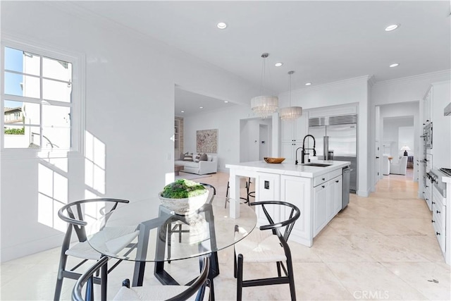 tiled dining area with sink, a chandelier, and ornamental molding