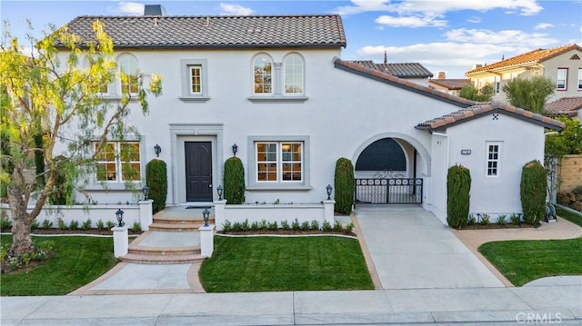 mediterranean / spanish home featuring a front yard