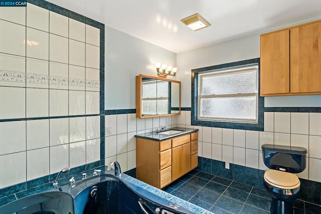 bathroom featuring tile patterned floors, vanity, a tub to relax in, and tile walls