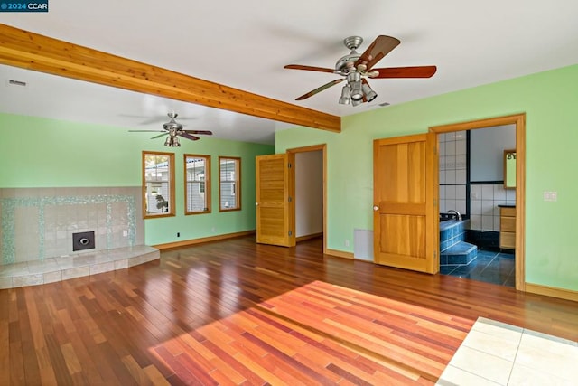 unfurnished living room with lofted ceiling with beams, hardwood / wood-style flooring, and ceiling fan