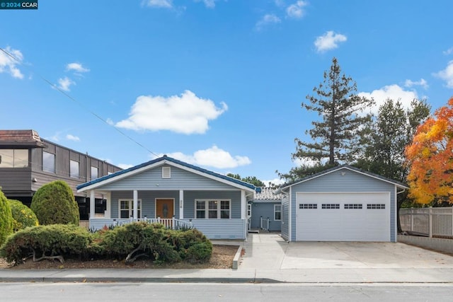 view of front of home featuring covered porch, an outdoor structure, and a garage