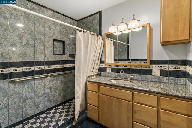 bathroom featuring tile patterned flooring, vanity, walk in shower, and tile walls