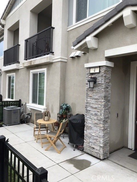 view of patio / terrace with a grill, a balcony, and central AC