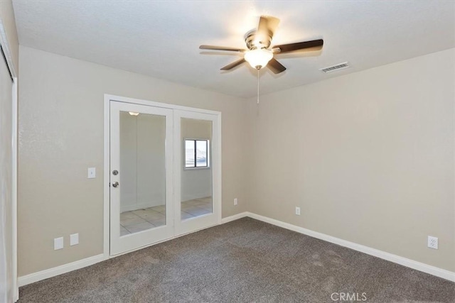 empty room with carpet, ceiling fan, and french doors