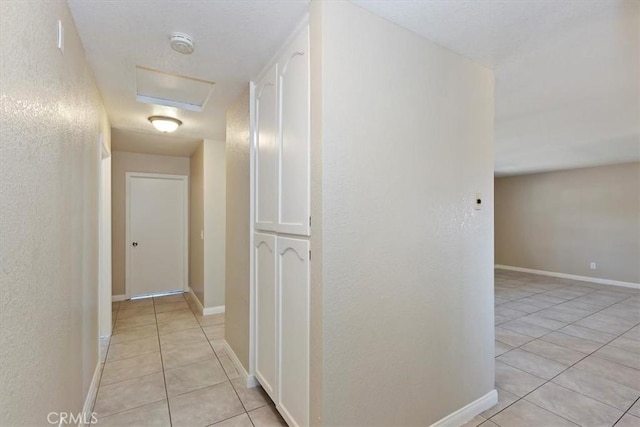 corridor with light tile patterned flooring