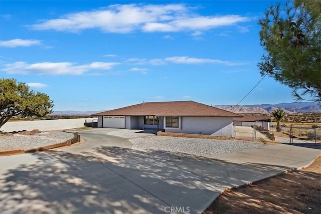 ranch-style home featuring a mountain view and a garage