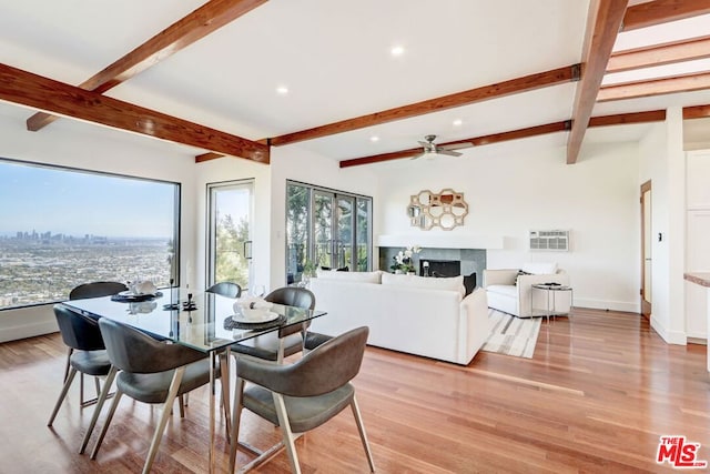 dining space with beamed ceiling, light wood-type flooring, and ceiling fan