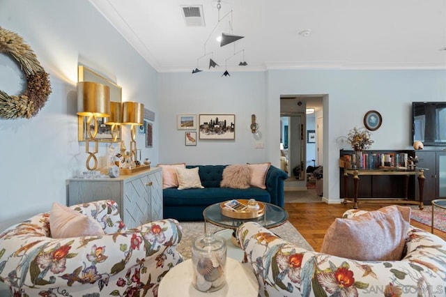 living room with crown molding and light hardwood / wood-style flooring