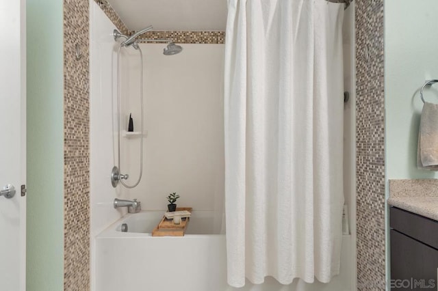 bathroom featuring shower / bath combo and vanity