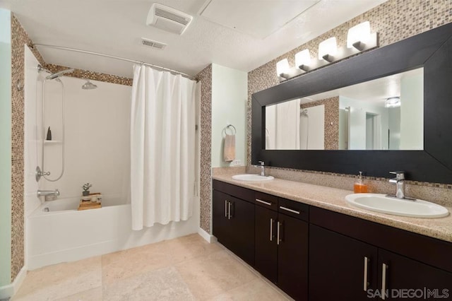 bathroom with tile patterned flooring, vanity, and shower / bath combo with shower curtain