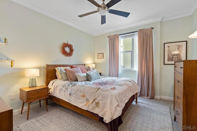 bedroom featuring crown molding, light carpet, and ceiling fan