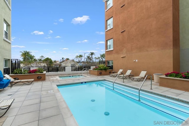 view of swimming pool with a patio area