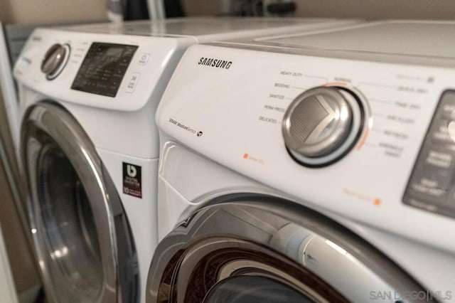 washroom with washing machine and clothes dryer