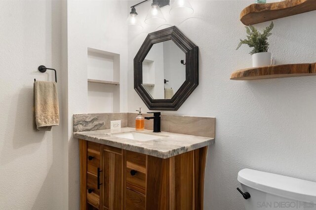 bathroom featuring vanity and toilet