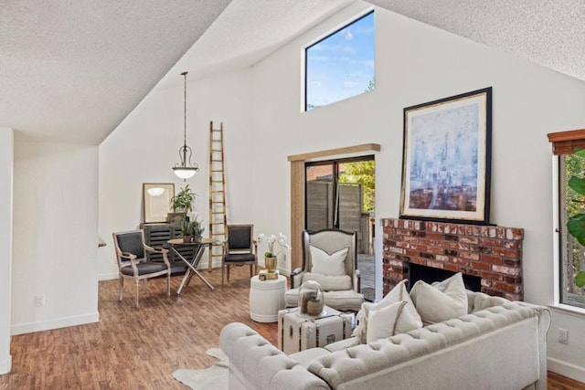 living room with vaulted ceiling, hardwood / wood-style floors, and a textured ceiling