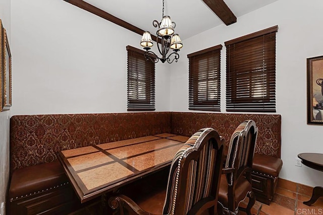 dining room featuring beamed ceiling and a chandelier