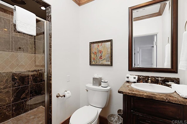 bathroom with vanity, a shower with shower door, and toilet