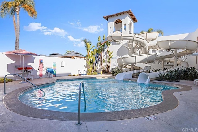 view of swimming pool featuring a patio and a water slide