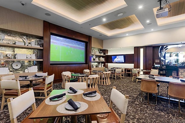 dining space with built in features and a tray ceiling