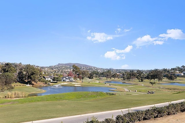 view of property's community with a yard and a water and mountain view