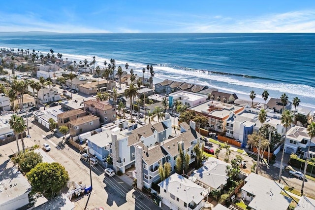 bird's eye view featuring a water view and a beach view