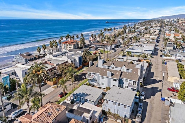 drone / aerial view featuring a water view and a view of the beach