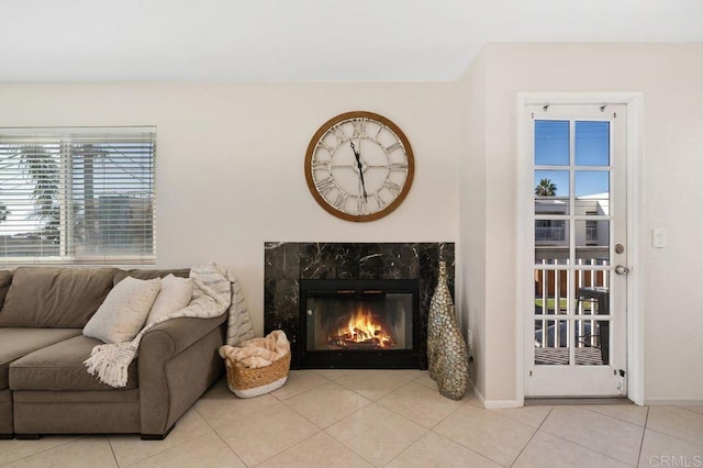 tiled living room featuring a premium fireplace