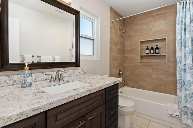 full bathroom with tile patterned flooring, vanity, shower / bath combo with shower curtain, and toilet