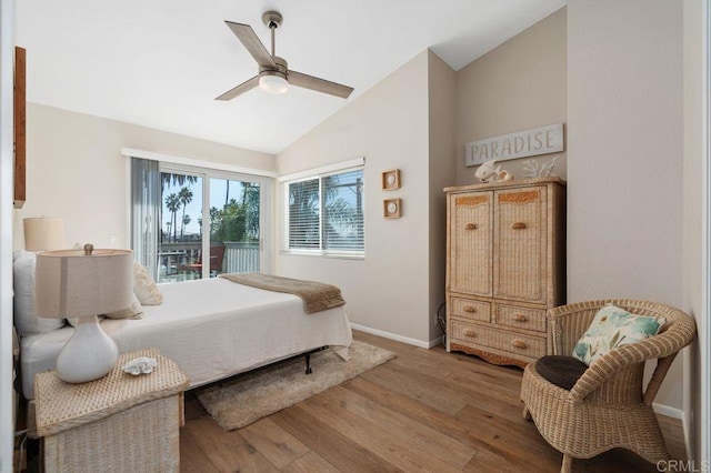 bedroom featuring ceiling fan, lofted ceiling, hardwood / wood-style floors, and access to outside