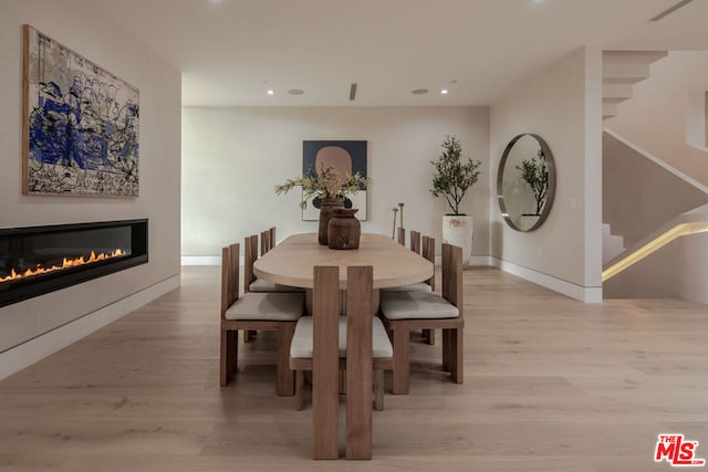 dining space featuring light wood-type flooring