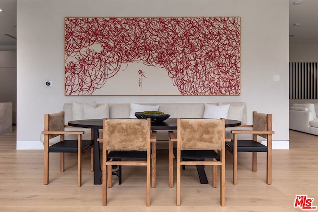 dining room featuring light wood-type flooring and breakfast area