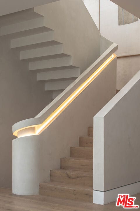 staircase with wood-type flooring