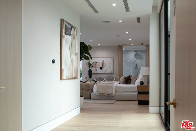 corridor with light hardwood / wood-style flooring