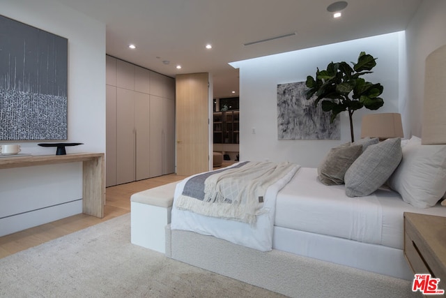 bedroom with light wood-type flooring