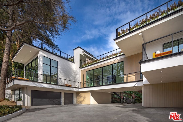 rear view of house featuring a garage