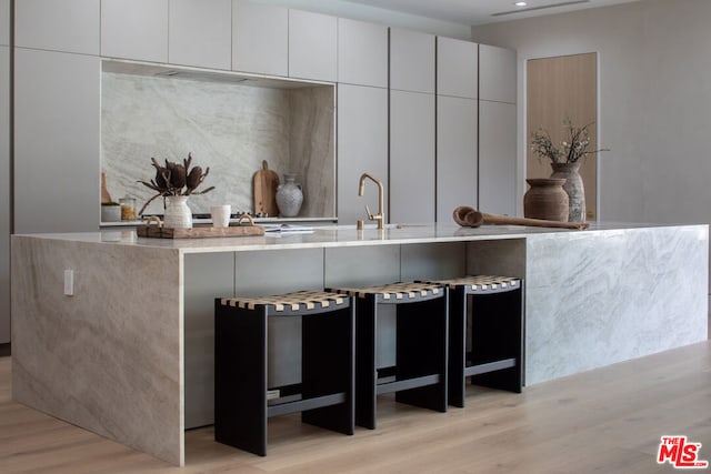 kitchen featuring light hardwood / wood-style floors and white cabinets