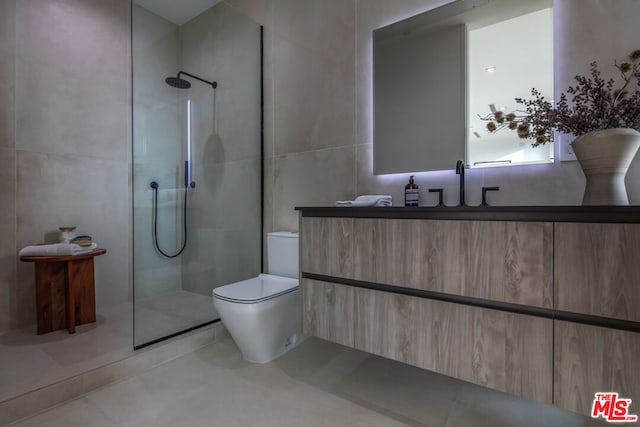 bathroom with toilet, vanity, tile walls, and tiled shower