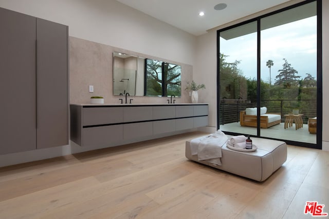 bathroom featuring vanity, hardwood / wood-style floors, and expansive windows