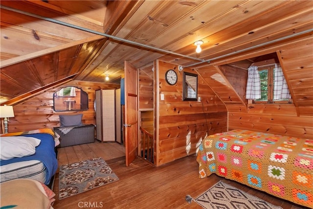 bedroom with wooden ceiling, wood walls, wood-type flooring, and vaulted ceiling