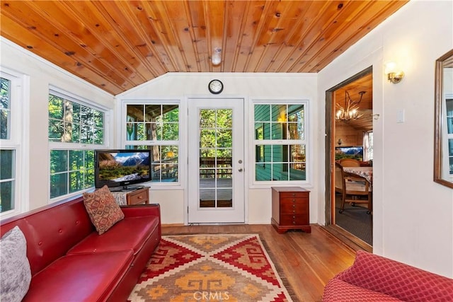 sunroom / solarium featuring wood ceiling, a healthy amount of sunlight, vaulted ceiling, and a notable chandelier