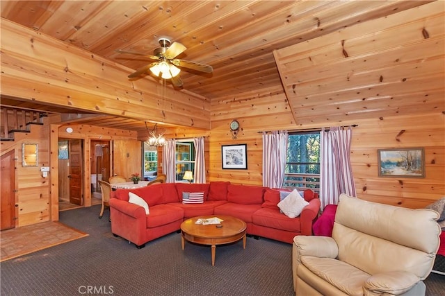 carpeted living room with wood ceiling, wooden walls, and ceiling fan with notable chandelier