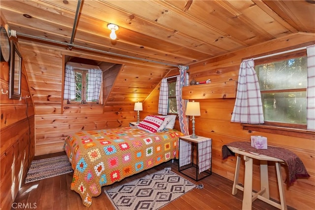 bedroom with vaulted ceiling, hardwood / wood-style floors, wooden ceiling, and wooden walls