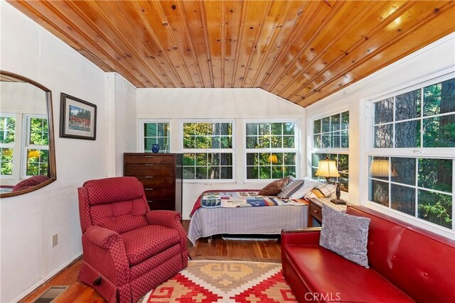 bedroom with wood ceiling, vaulted ceiling, and hardwood / wood-style flooring