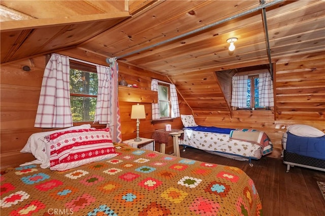 bedroom with dark hardwood / wood-style flooring, vaulted ceiling, and wood walls