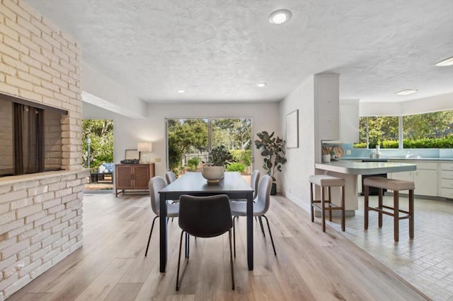 dining room featuring a fireplace and light wood-type flooring