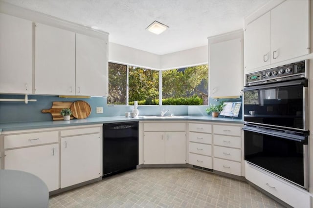 kitchen with white cabinets, backsplash, and black appliances