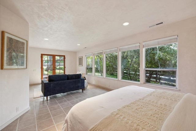 tiled bedroom featuring french doors