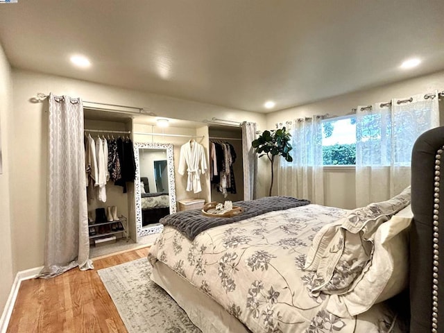 bedroom with wood-type flooring and a closet