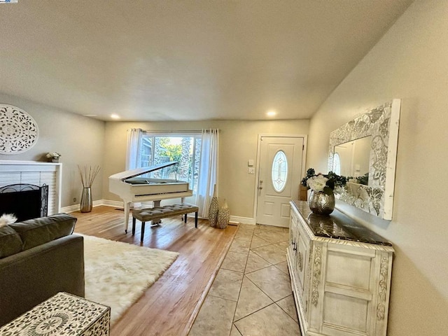 foyer with a fireplace and light hardwood / wood-style floors