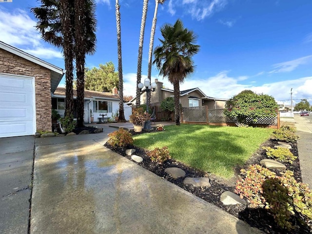 view of front of home with a garage and a front lawn